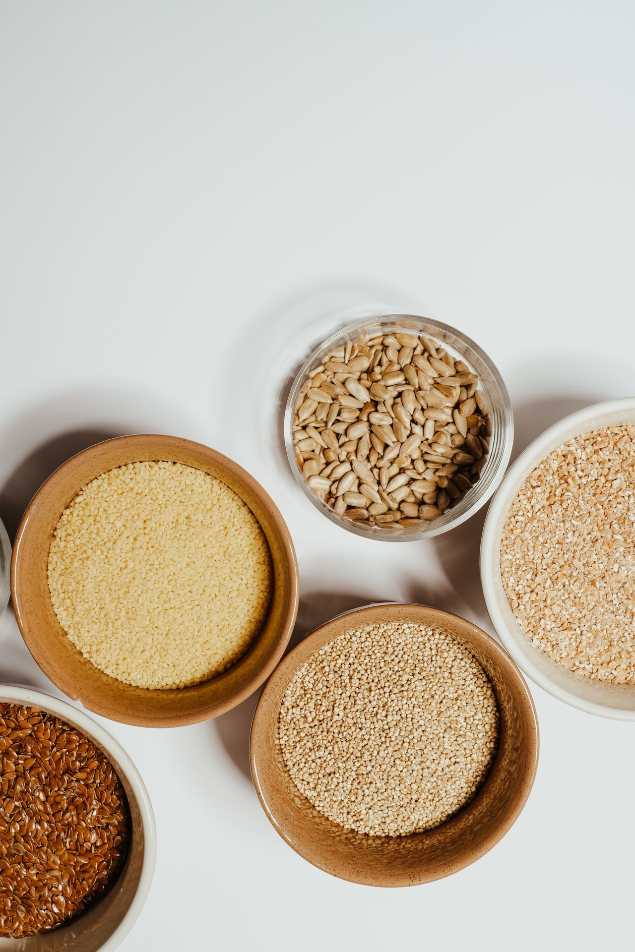 Wholesale display of pearl barley and cereal groats in bowls for retail distribution